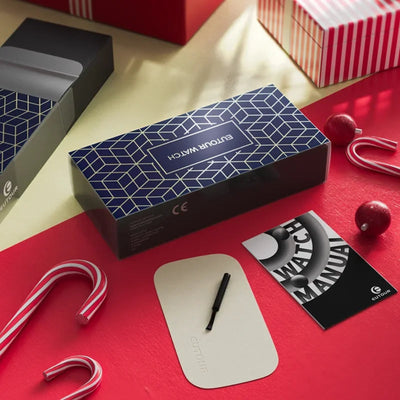 Gorillowatch packaging with watch, manual, and pen on a red surface