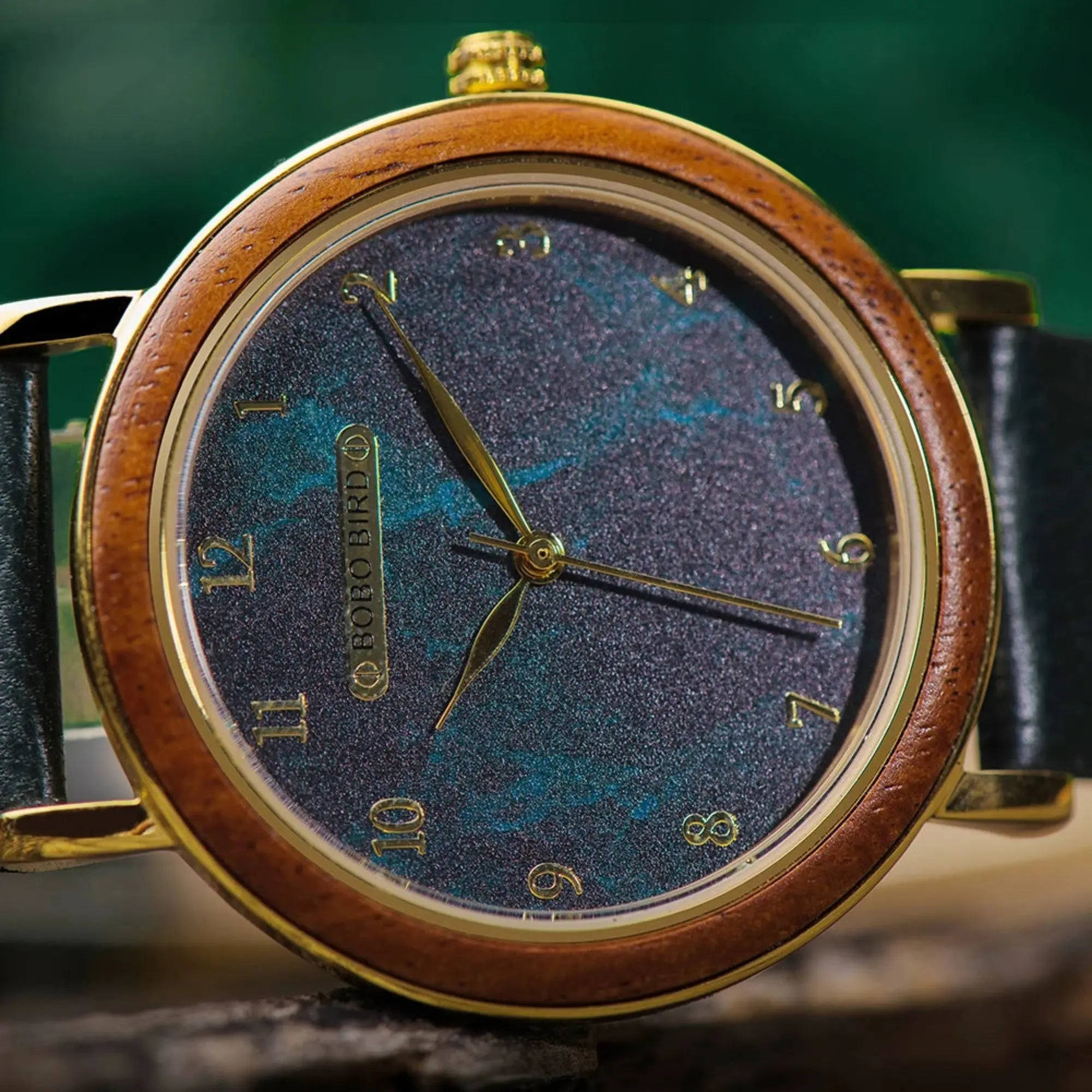 Watch with wooden casing and blue textured face on a blurred background