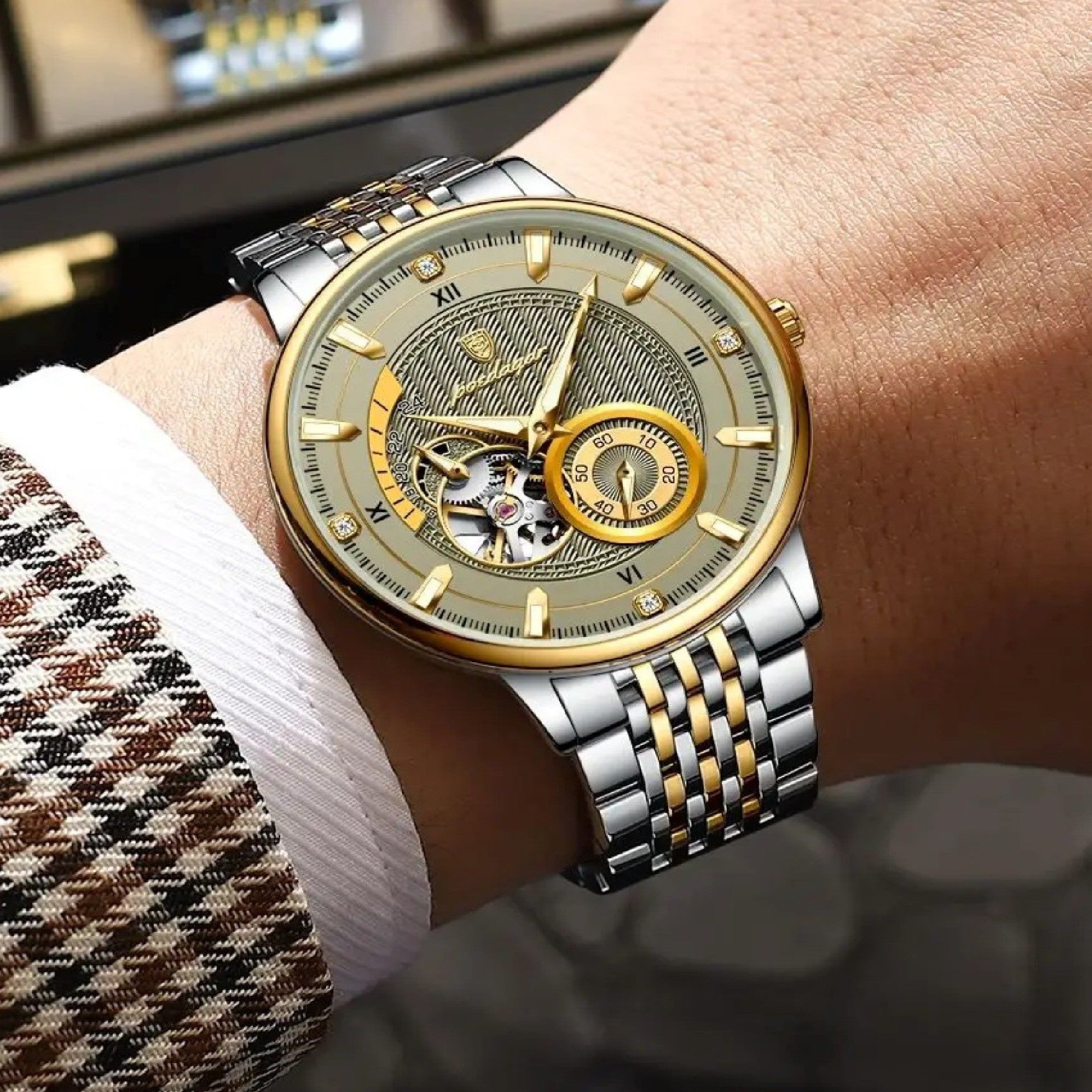 Luxury watch with silver and gold band on a wrist