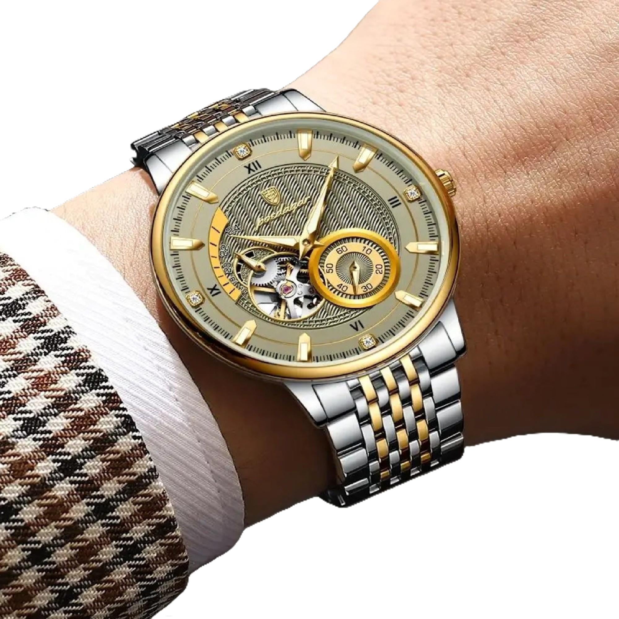 Luxury watch with a gold and silver strap on a wrist, against a neutral background.