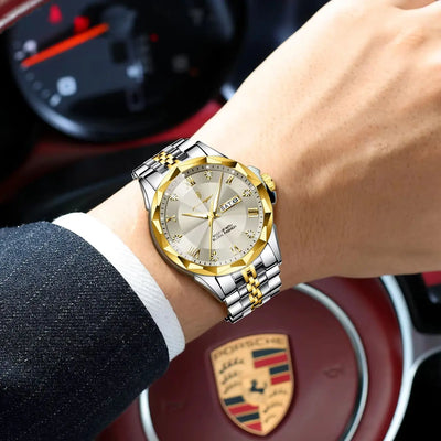 A men's luxury watch with a gold and silver two-tone octagonal bezel, gold sunburst dial, and matching metal link bracelet, shown worn on a wrist inside a Porsche-branded car interior.