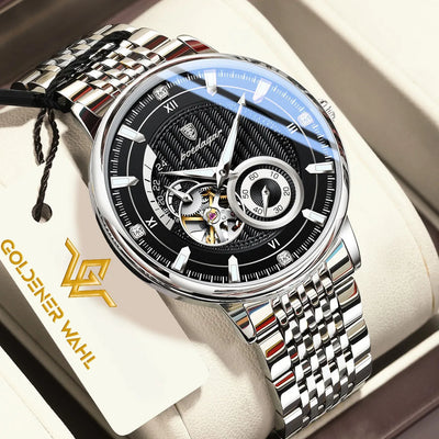 Goldener Wahl automatic mechanical watch with a silver stainless steel link bracelet, black dial, and skeletonized movement visible at the 6 o'clock position, presented in its cream-colored box with a branded hangtag.