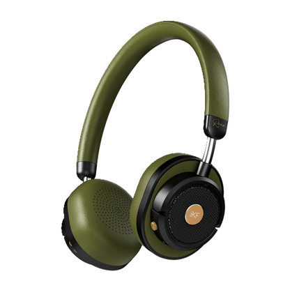 Premium over-ear headphones placed on a sound mixing console in a professional recording studio