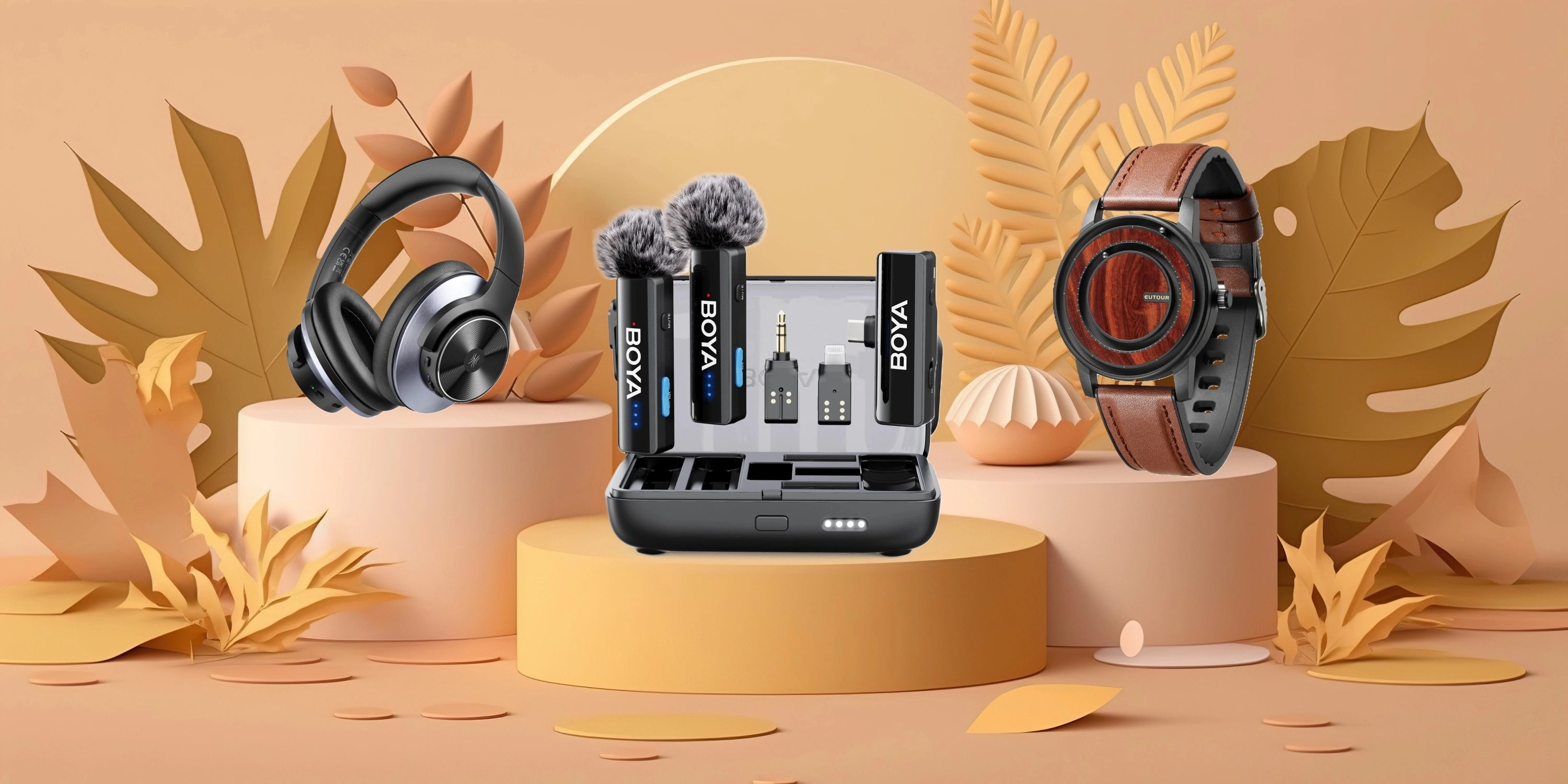 A BOYA wireless microphone kit with a lavalier mic, two clip-on mics, and a battery charger, styled on a yellow pedestal with a watch and headphones on either side against a warm beige background with decorative leaves.