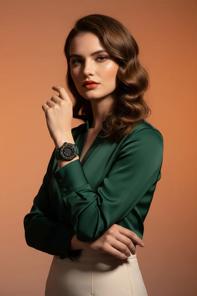 Woman wearing a green blouse and white pants against an orange background