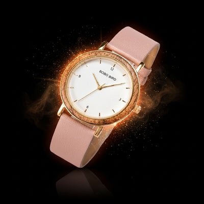 Watch with pink strap and gold casing on a dark background