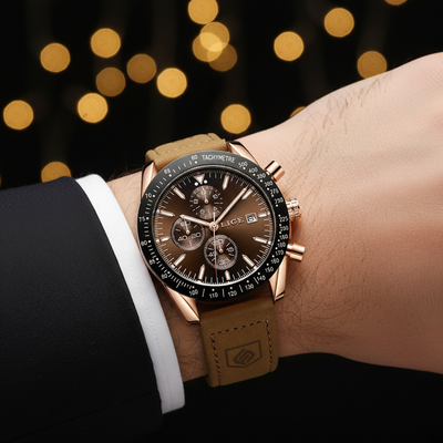 Luxury watch with brown leather strap on a wrist against a blurred lights background