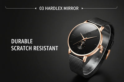 Watch with black hardlex mirror and rose gold accents on a dark background