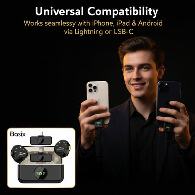 Person holding two smartphones with Basix charging adapter on a black background